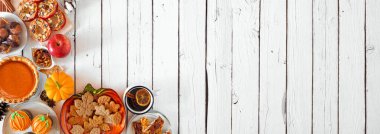 Sonbahar tatlıları köşe kenarı sınırı. Tatlı sonbahar ikramlarıyla dolu bir masa sahnesi. Beyaz ahşap bir arka planda yukarıdan görüntü. Boşluğu kopyala.