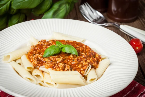 Penne a bolognese on white plate. — Stock Photo, Image