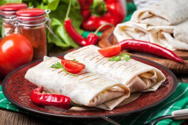 Burritos filled wiht minced meat, bean and vegetables. clipart