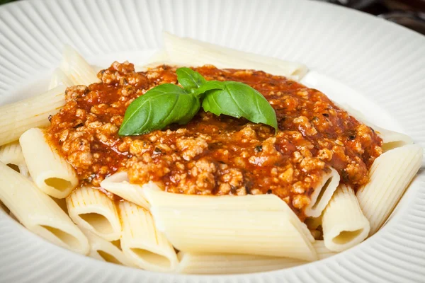 Penne a bolognese on white plate. — Stock Photo, Image