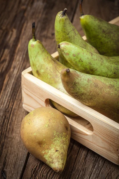 Fresh pears in a box on wooden background. — Stock Photo, Image