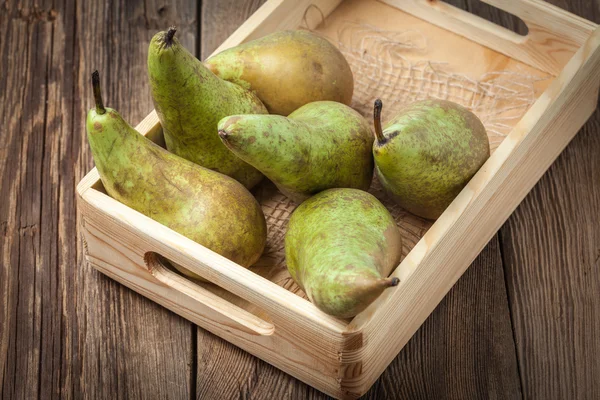 Fresh pears in a box on wooden background. — Stock Photo, Image