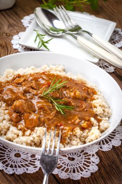 Pişmiş arpa yulaf lapası ve domuz eti güveç.