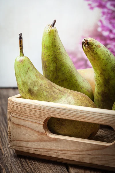 Fresh pears in a box on wooden background. — Stock Photo, Image