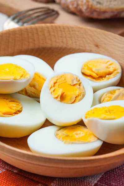 Half-boiled eggs in a wooden bowl. — Stock Photo, Image