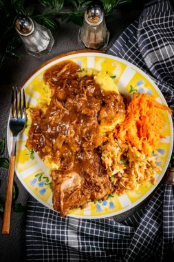 Patates püresi ve salatayla servis edilen acılı soslu domuz pirzolası. Sığ alan derinliği.