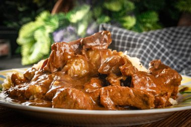 Lezzetli soslu sığır eti güveci, lahanayla servis edilir..