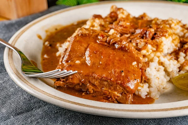 Baharat soslu haşlanmış domuz kaburgası arpa ve salatalık turşusu ile servis edilir. Seçici odak.