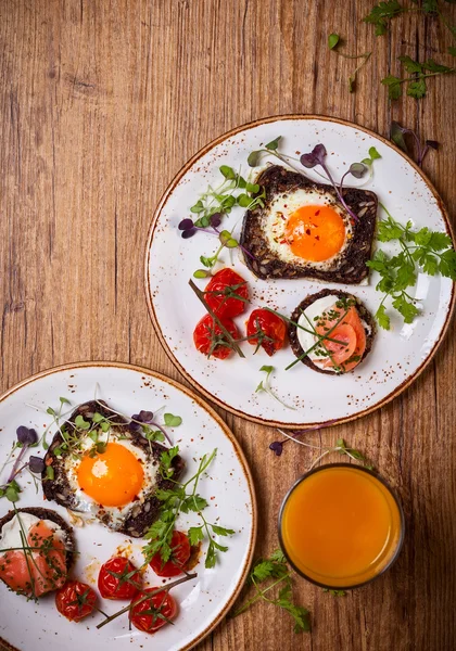 Fried eggs, salmon canape and tomatoes — Stock Photo, Image