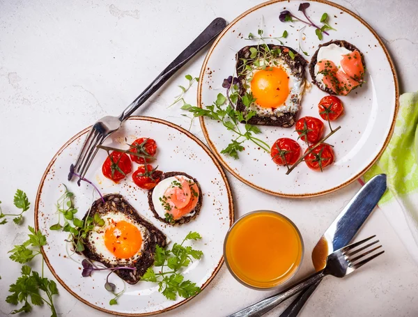 Fried eggs, salmon canape and tomatoes — Stock Photo, Image