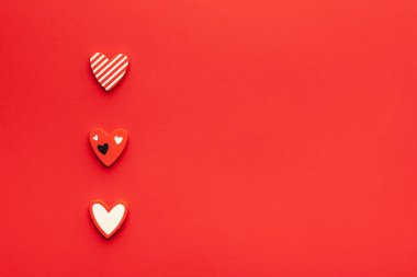 Sevgililer Günü ya da Düğün Romantik Konsepti. Kırmızı arkaplanda kırmızı kalpler. Üst görünüm, düz görünüm, kopyalama alanı.