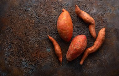 Kırmızı patatesler dokulu arka planda. Kök sebze hasadı. Sağlıklı gıda kavramı.