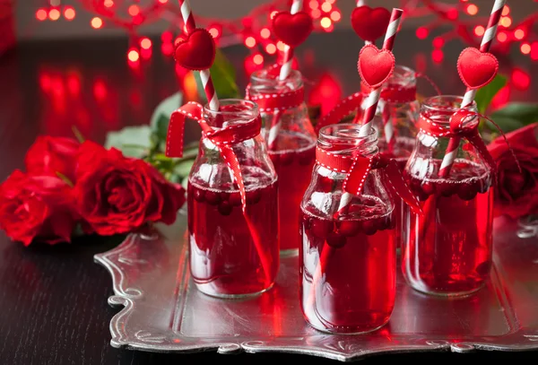 Small bottles with cranberry cocktail — Stock Photo, Image