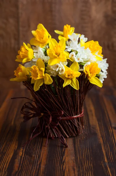 Daffodils in a twig vase — Stock Photo, Image
