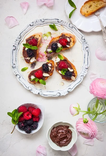 Berry bruschetta with chocolate nut butter — Stock Photo, Image