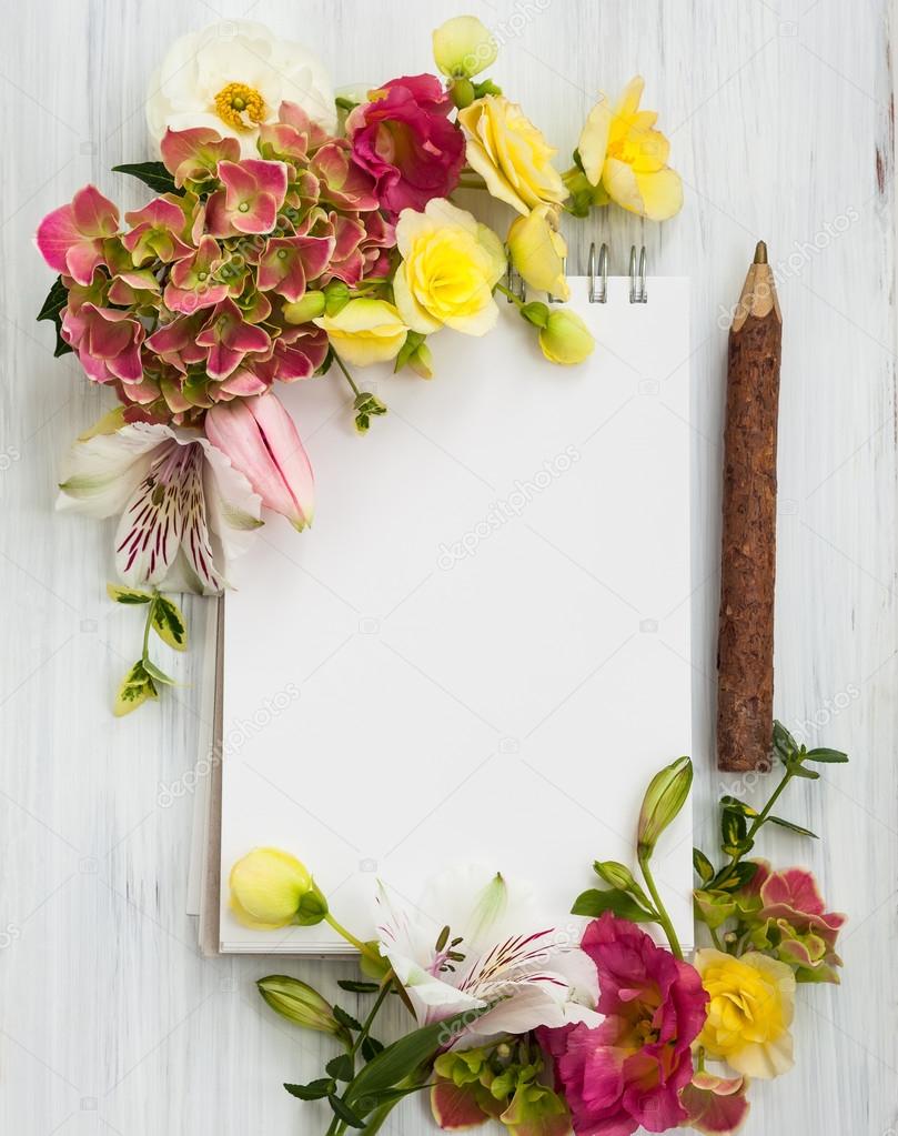 Flowers and notepad with copy space