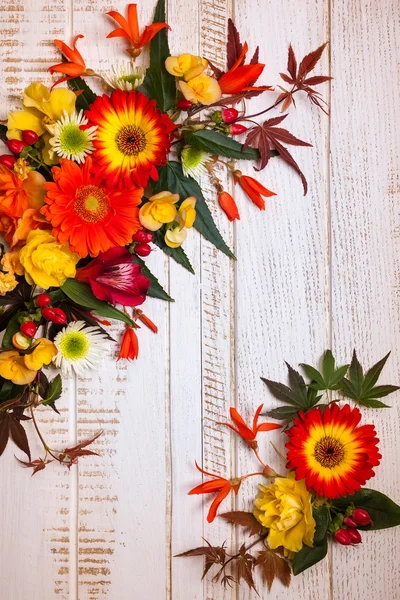 Autumnal flowers on vintage wooden background — Stock Photo, Image