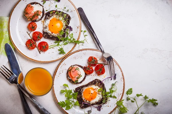 Huevos fritos, canapé de salmón y tomates —  Fotos de Stock