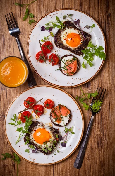 Fried eggs, salmon canape and tomatoes — Stock Photo, Image