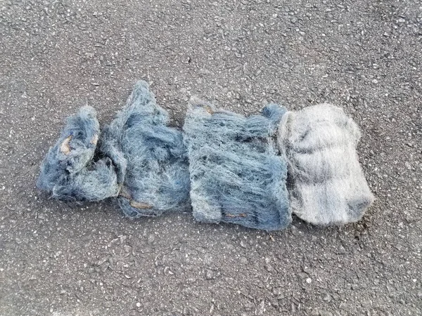 burned and regular steel wool on asphalt