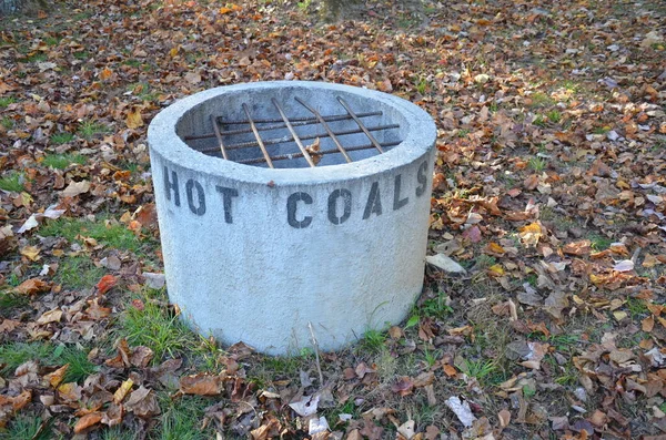 Cement hot coal fire pit with metal grate — Stock Photo, Image