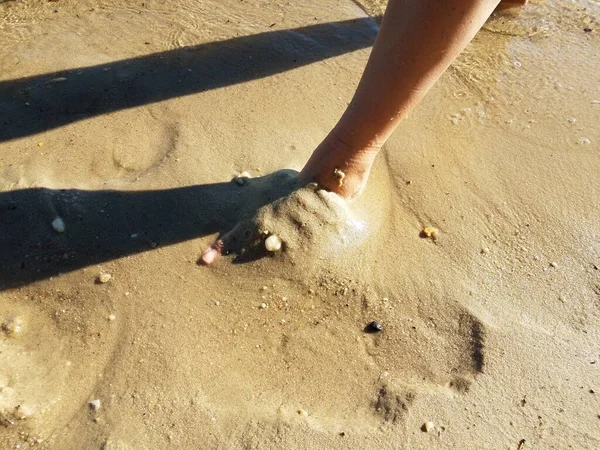 Mulheres pés de pé na areia molhada na praia — Fotografia de Stock