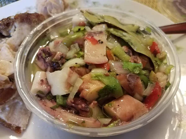 Octopus salad with peppers in plastic container — Stock Photo, Image