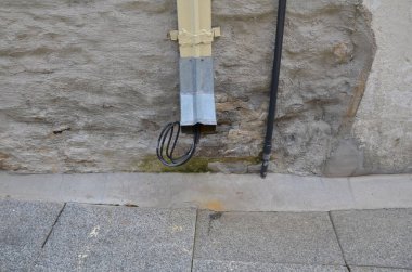 Kablo ve gri taş duvarlarla dolu bir oluk.