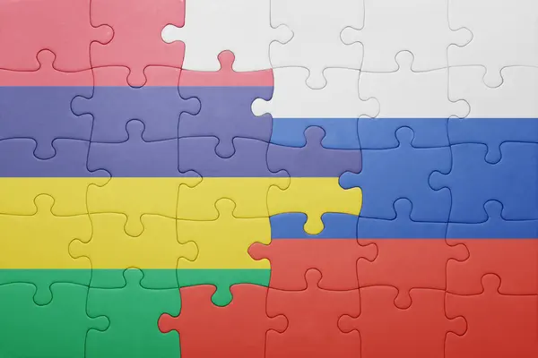 Puzzle z flagą narodową Rosji i Mauritiusa . — Zdjęcie stockowe