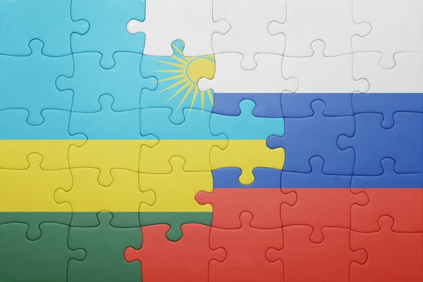 Puzzle with the national flag of russia and rwanda — Stock Photo, Image