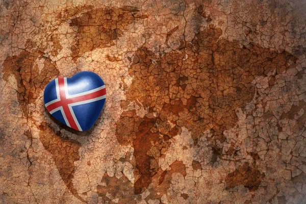 Серце з національним прапором Ісландії на вінтажній карті світу тріщин паперу фон — стокове фото