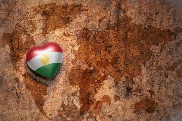Heart with national flag of kurdistan on a vintage world map crack paper background. — Stock Photo, Image