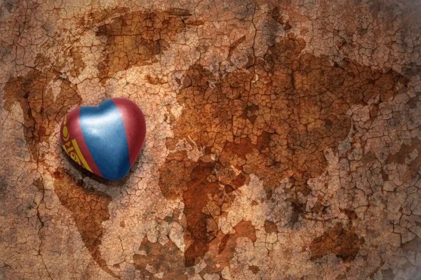 Heart with national flag of mongolia on a vintage world map crack paper background. — Stock Photo, Image