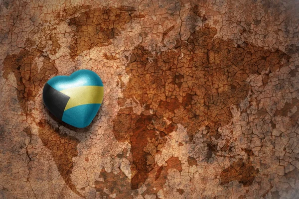 Heart with national flag of bahamas on a vintage world map crack paper background. concept — Stock Photo, Image