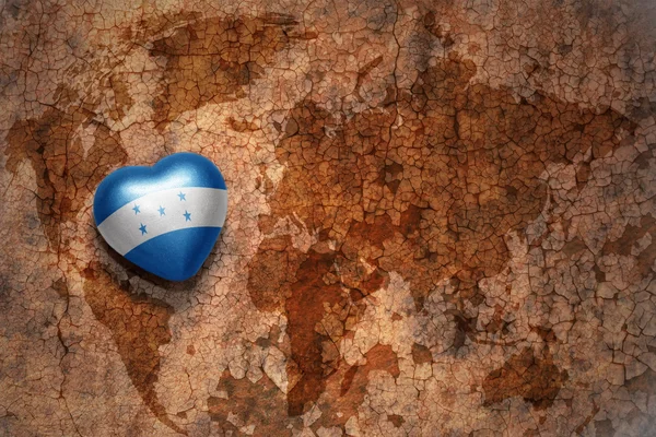 Heart with national flag of honduras on a vintage world map crack paper background. concept — Stock Photo, Image
