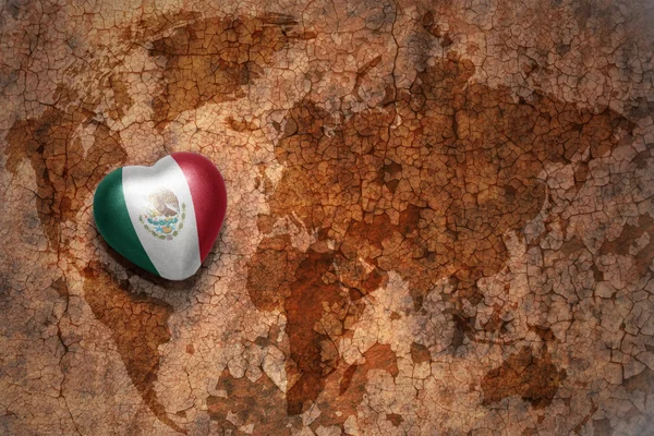 Heart with national flag of mexico on a vintage world map crack paper background. concept — Stock Photo, Image