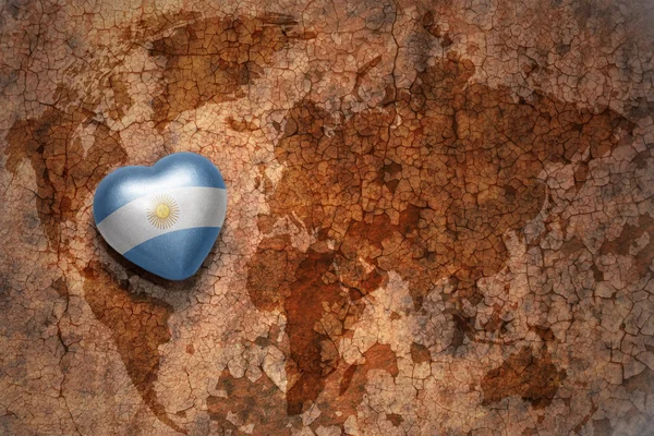 Серце з національним прапором Аргентини на карті світу тріщин паперу фону. концепція — стокове фото