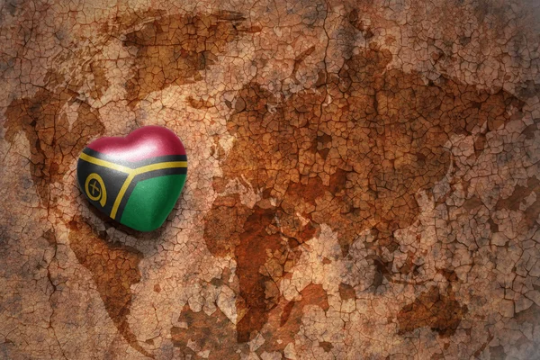 Heart with national flag of Vanuatu on a vintage world map crack paper background. concept — Stock Photo, Image