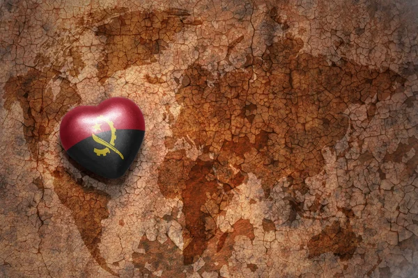 Heart with national flag of angola on a vintage world map crack paper background. — Stock Photo, Image