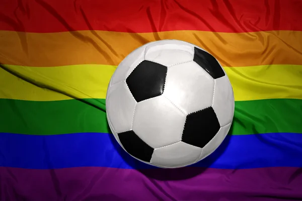 Чорно-білий футбольний м'яч на веселковому гей-прапорі — стокове фото