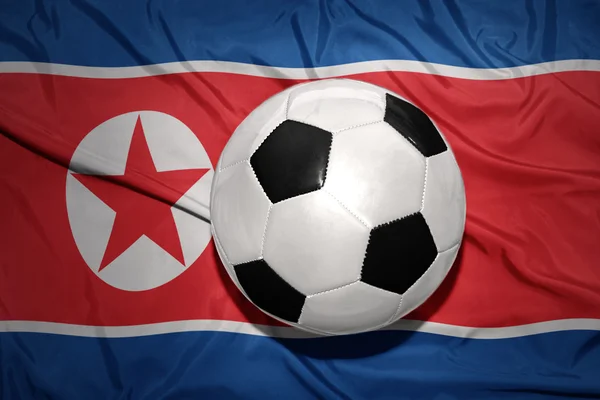 Svart och vit Fotboll boll på den nationella flaggan i Nordkorea — Stockfoto