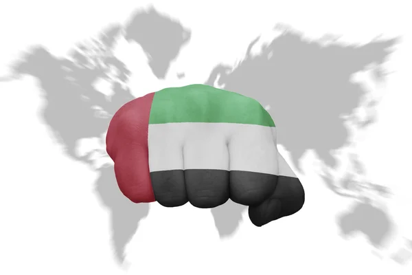 Fist with the national flag of united arab emirates on a world map background — Stock Photo, Image