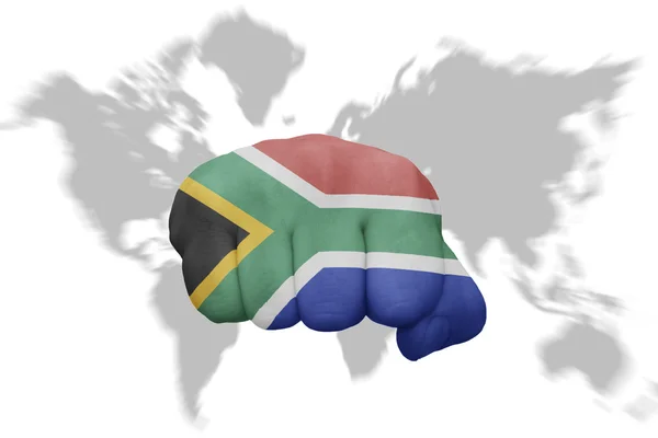 Fist with the national flag of south africa on a world map background — Stock Photo, Image