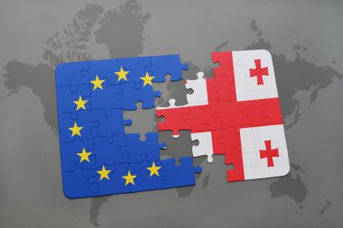 bir dünya haritası arka plan üzerinde Gürcistan ve Avrupa Birliği ulusal bayrağı ile bulmaca.