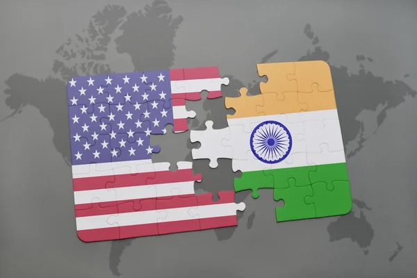 Puzzle with the national flag of united states of america and india on a world map background — Stock Photo, Image