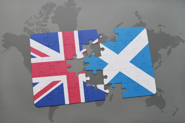 Puzzle with the national flag of great britain and scotland on a world map background — Stock Photo, Image