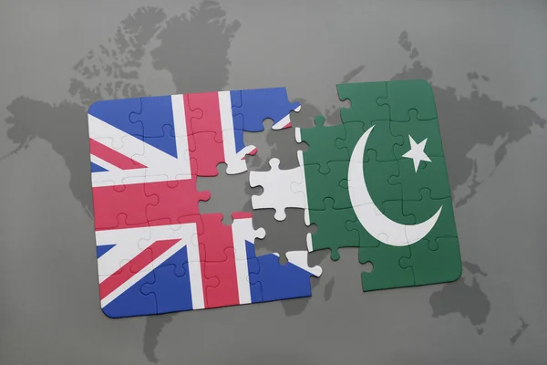 Puzzle with the national flag of great britain and pakistan on a world map background. — Stock Photo, Image