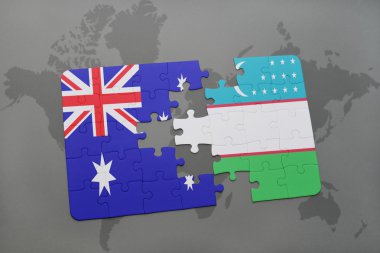 bir dünya haritası arka plan üzerinde Avustralya ve Özbekistan ulusal bayrağı ile bulmaca.