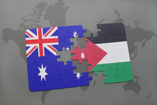 Puzzle with the national flag of australia and jordan on a world map background. — Stock Photo, Image