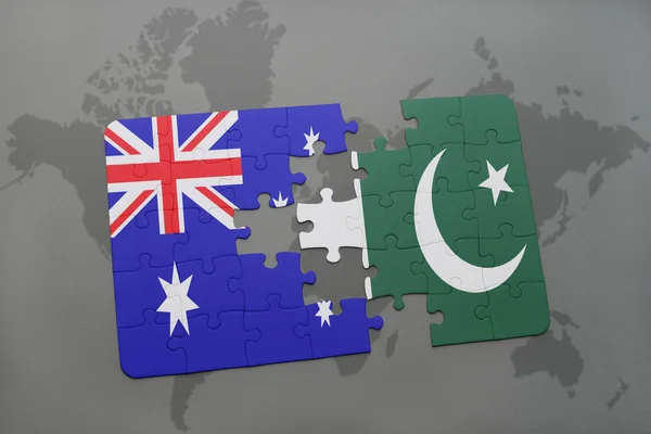 Puzzle with the national flag of australia and pakistan on a world map background. — Stock Photo, Image
